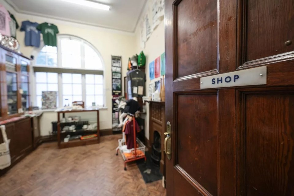 a wooden door with a shop sign on it