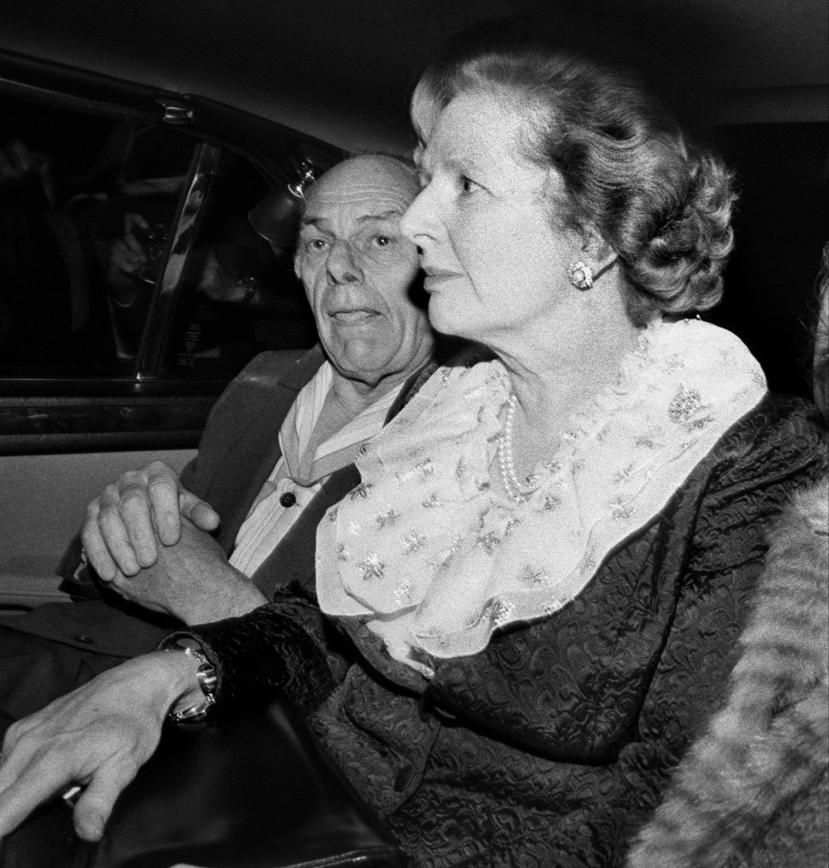 a black and white photo of a man and woman in a car