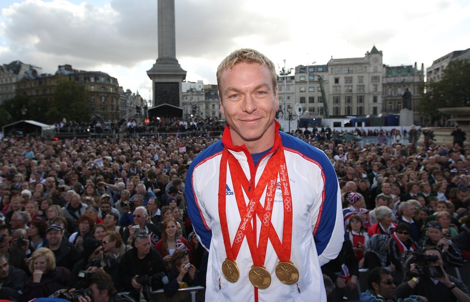 a man wearing three gold medals from the london olympics