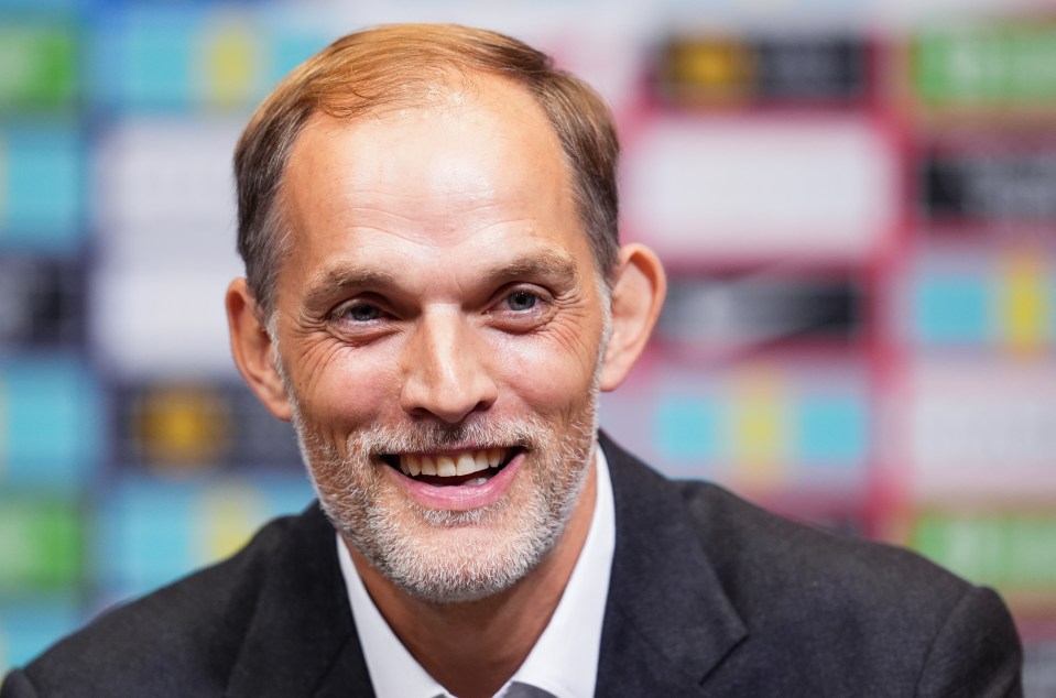 a man with a beard is smiling and wearing a suit