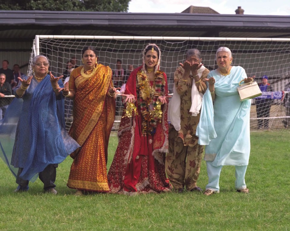 a group of women standing in front of a soccer goal