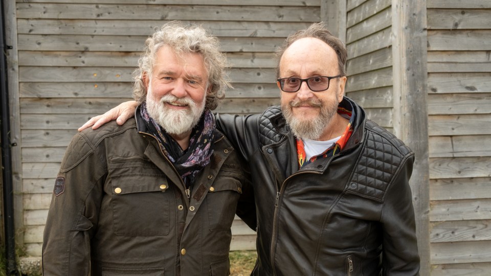 two men standing next to each other with one wearing a jacket that says ' abercrombie & fitch ' on it