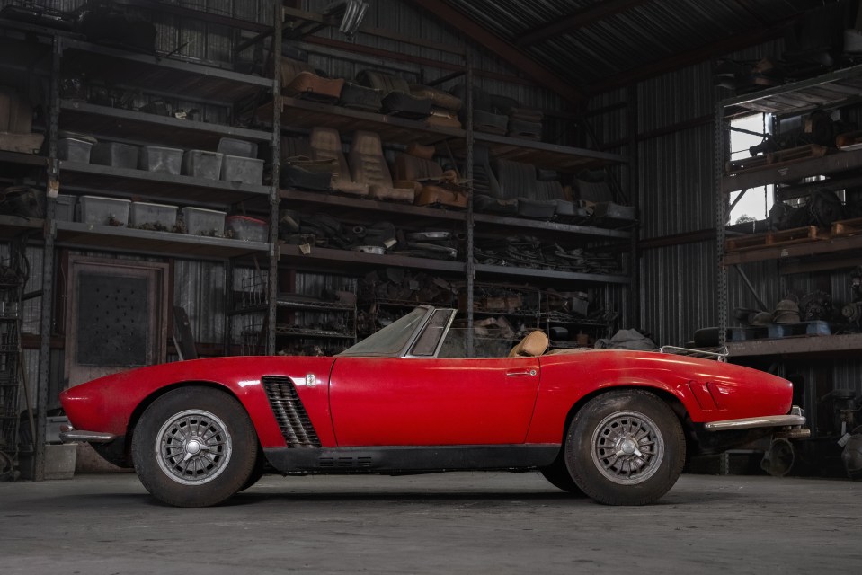 a red sports car is parked in a garage