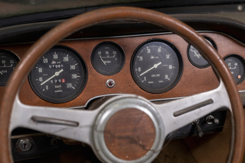 a close up of a car dashboard with a speedometer reading 57.9565