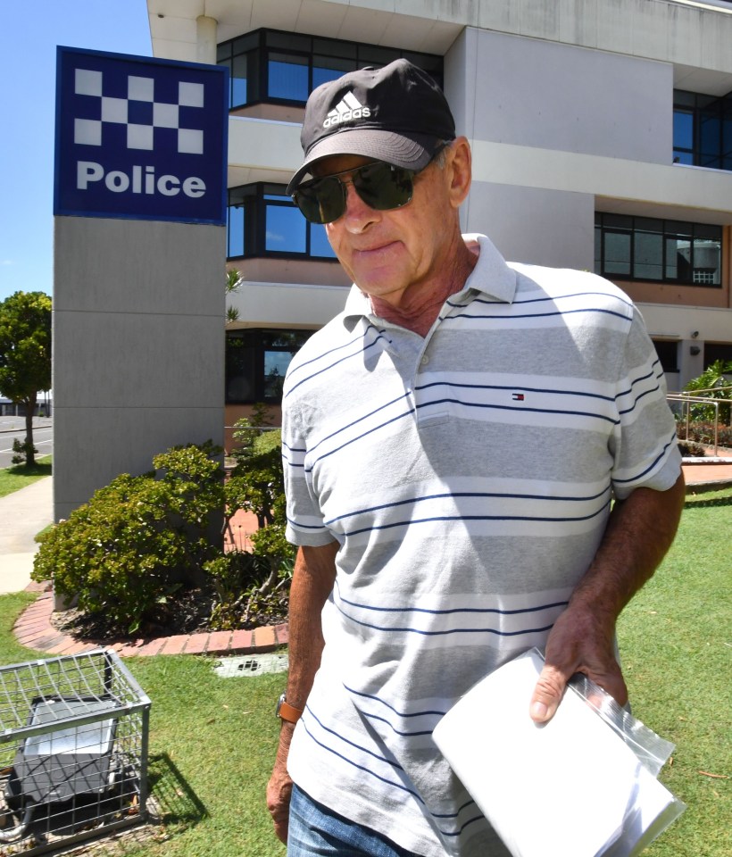 a man standing in front of a police building