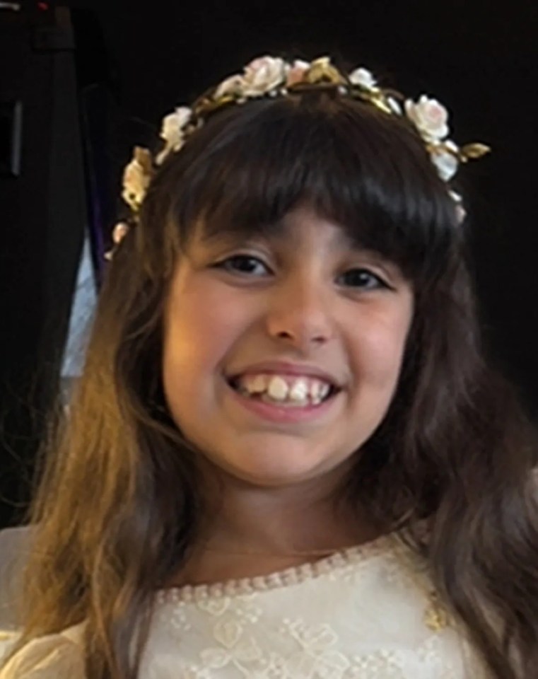 three little girls are smiling for the camera and one has a flower crown on her head