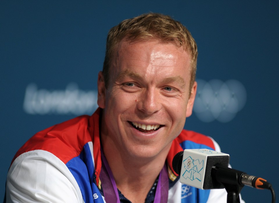 a man with a medal around his neck is smiling in front of a london sign