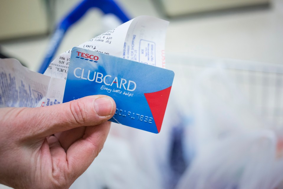 a person is holding a clubcard in their hand