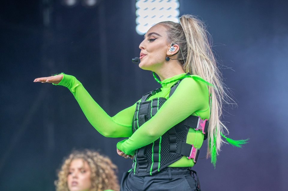 a woman in a neon green outfit with a microphone on her head