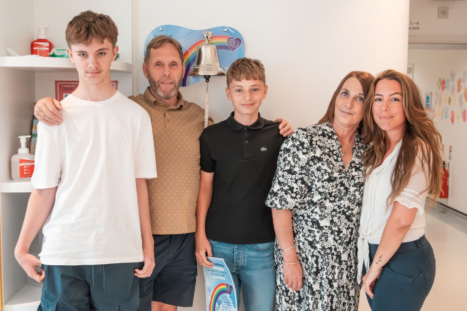 George, centre, pictured with twin Stephen, father Steven, mum Christine and donor Kimmy