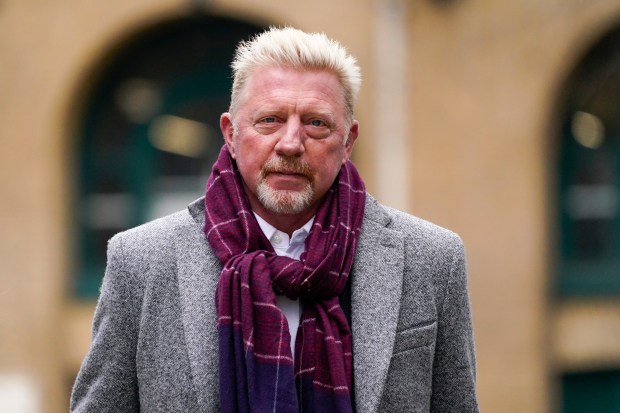 a man wearing a gray jacket and a purple scarf