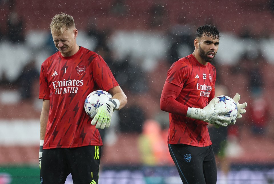 two soccer players wearing red shirts that say emirates fly better