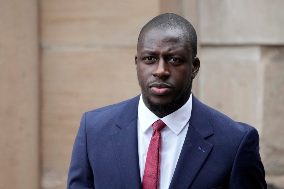 a man in a suit and tie looks at the camera