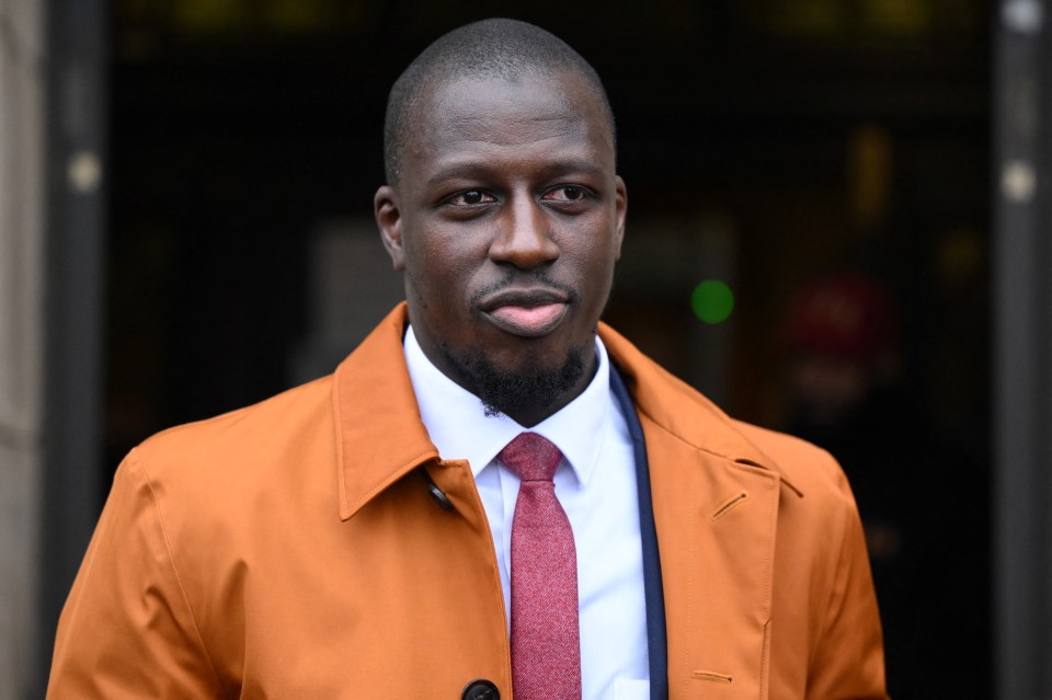 a man wearing an orange coat and a red tie