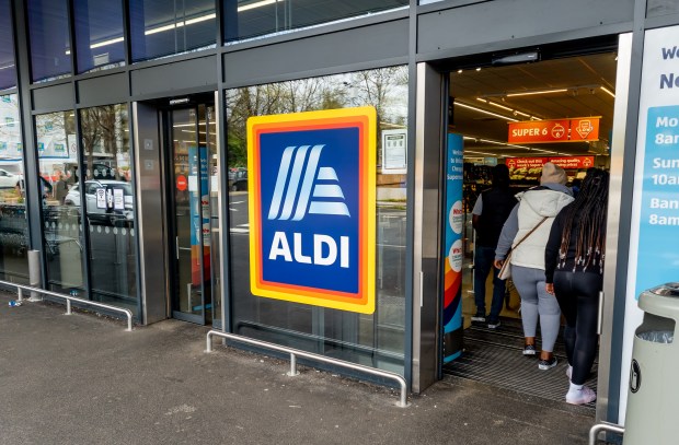 a group of people are entering an aldi store