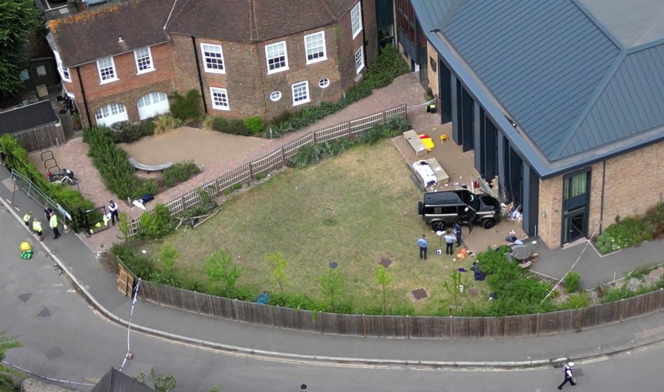 an aerial view of a house with a black suv parked in the backyard