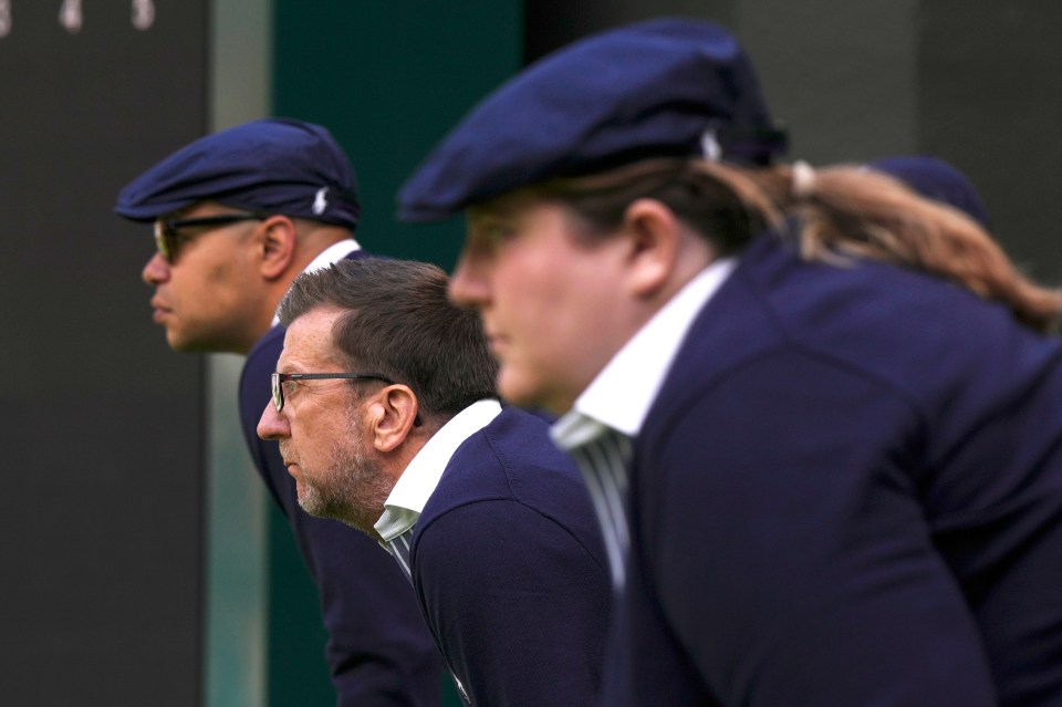 a group of people wearing blue hats are lined up in a row