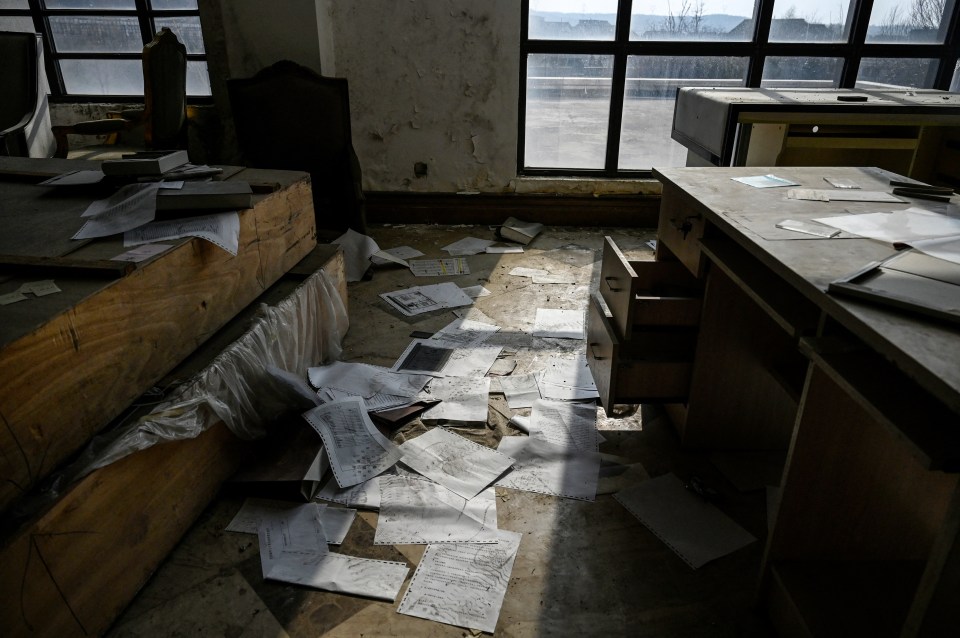 Papers and other signs of life can be seen laying around the shells of these buildings