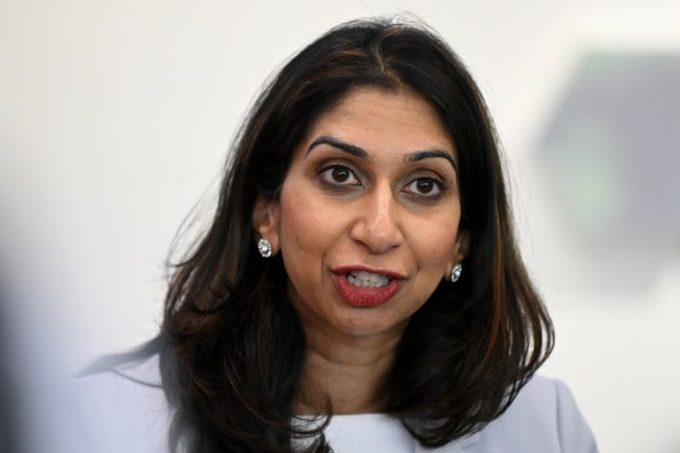 a close up of a woman wearing earrings and a white shirt