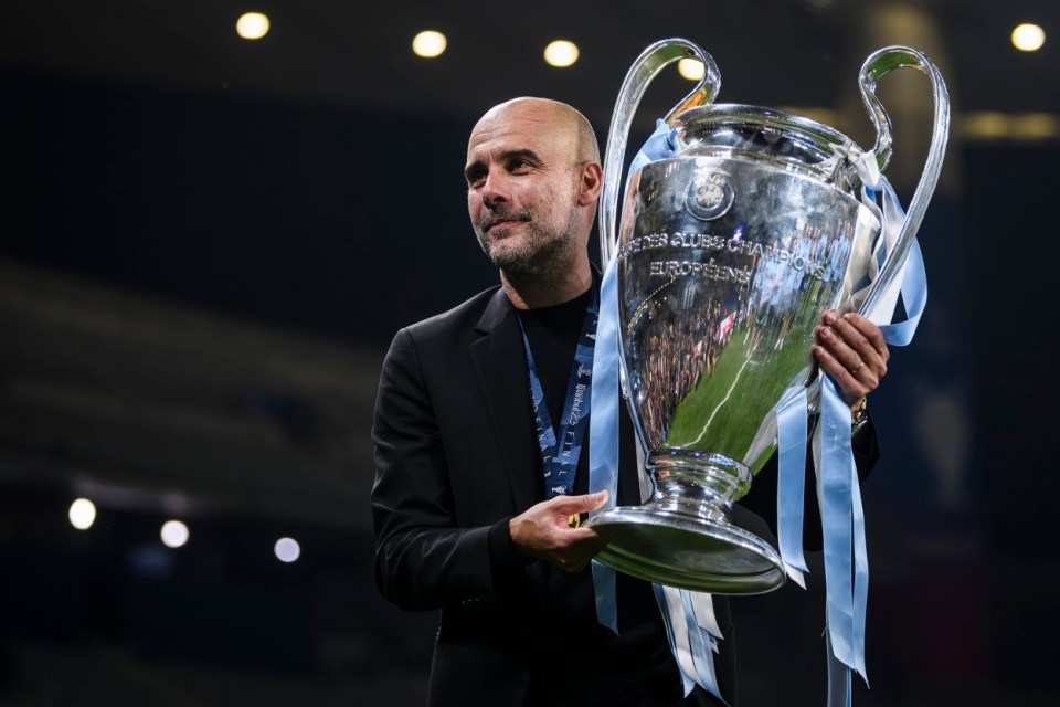 a man holding a trophy that says ' champions league ' on it