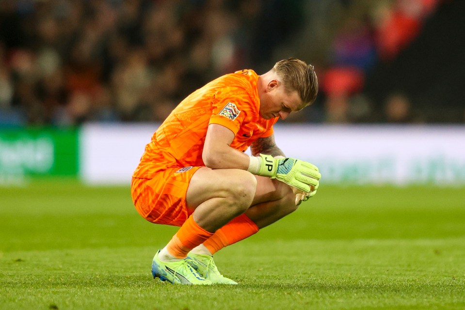 a soccer player kneeling on the field with the letter p on his shirt