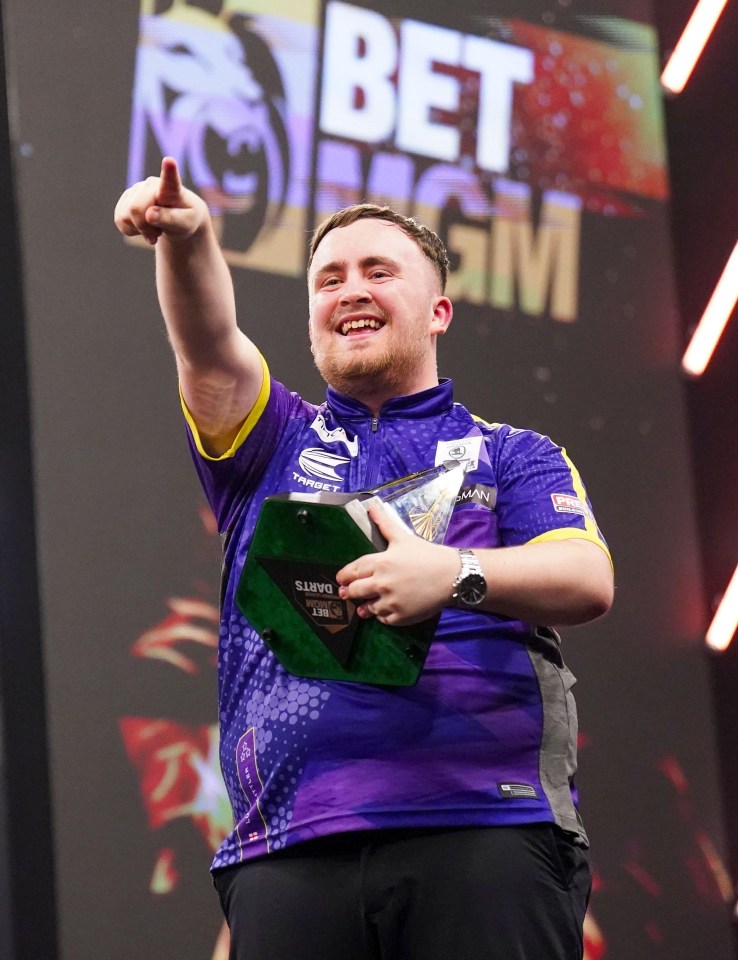 a man in a purple shirt with the word darts on it