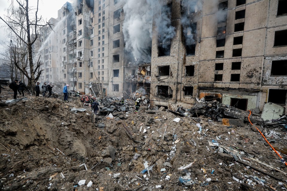 Rescuers work at the site of a damaged building after a missile strike in Kyiv