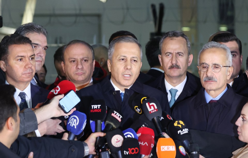 a group of men are standing in front of microphones including one that says trt kurdi