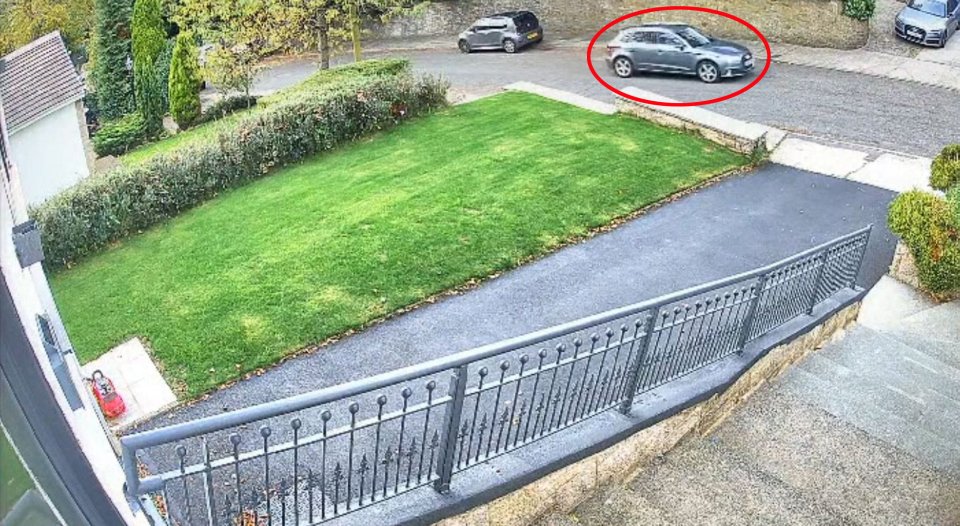 The grey Audi can be seen moments before the incident, travelling along a quiet residential road