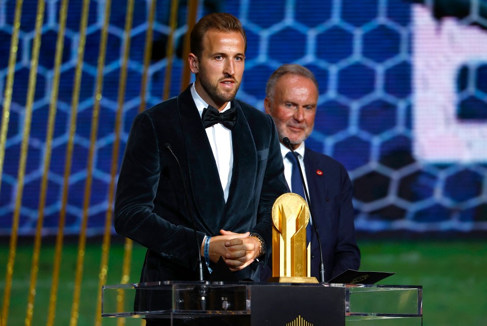 Kane receives the Gerd Muller Trophy from Germany legend Karl-Heinz Rummenigge