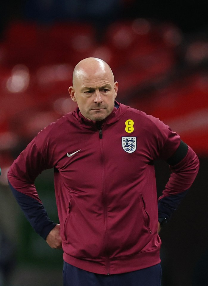 a man wearing a maroon nike jacket with the letter e on it