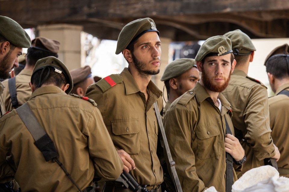 Members of the Israeli army attend the funeral for one of the soldiers killed on Sunday