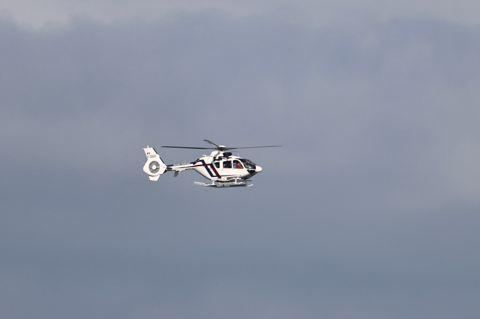 A French customs helicopter flies over Bleriot beach in Calais earlier today