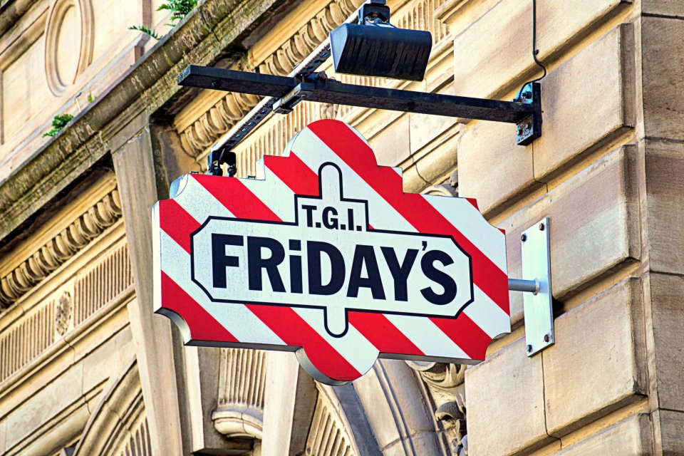 a red and white sign for t.g.i. friday 's