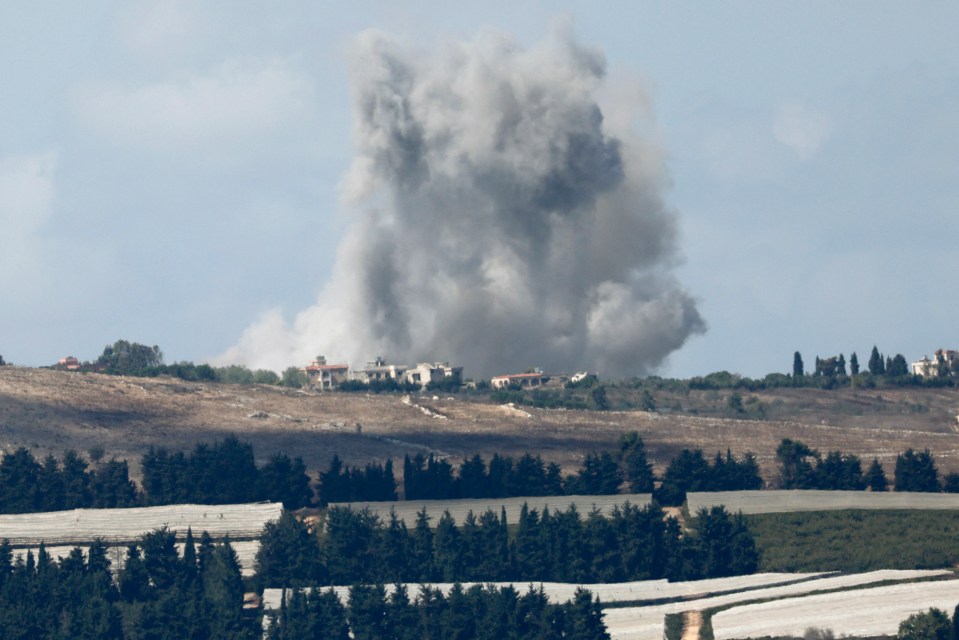 a large cloud of smoke is coming out of a field