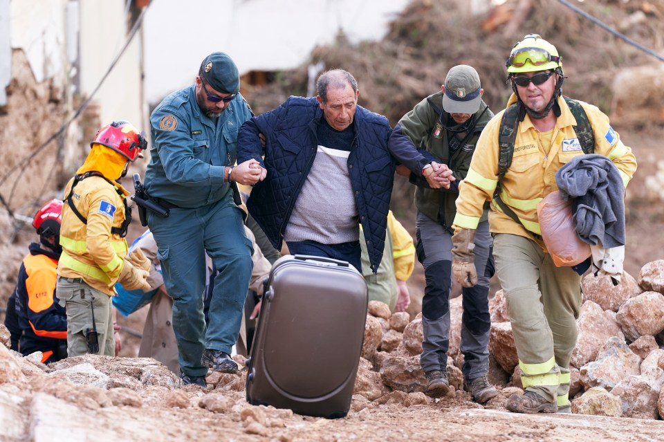 Rescue workers help get a man to safety