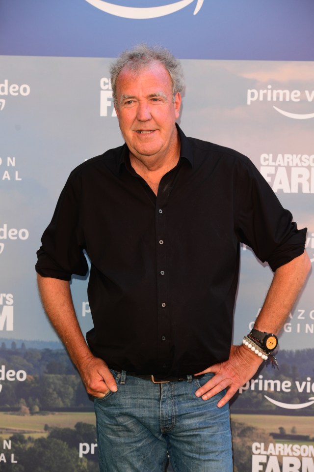 a man in a black shirt stands in front of a sign that says clarkson farm