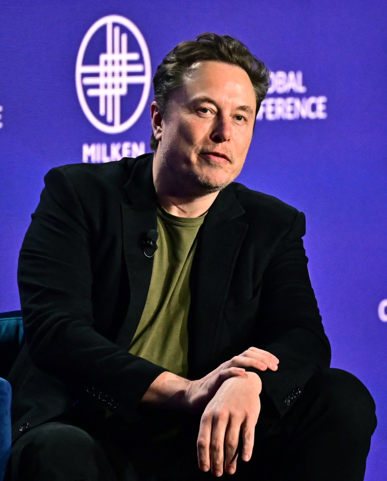 a man sitting in front of a sign that says global conference