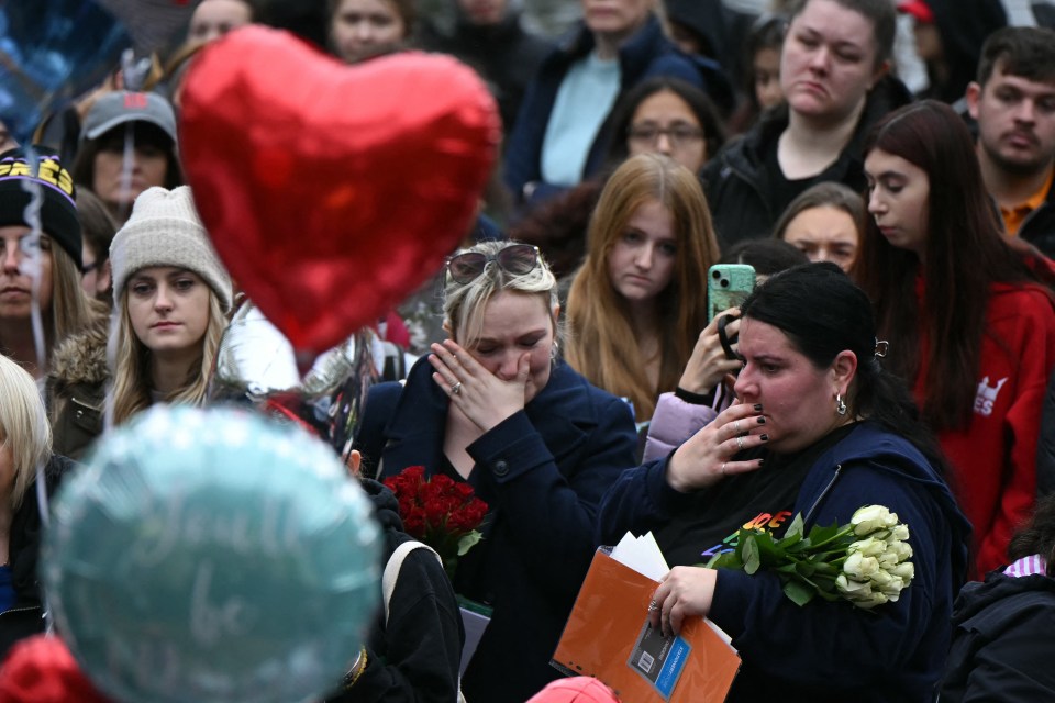 Emotional fans leaving roses and balloons