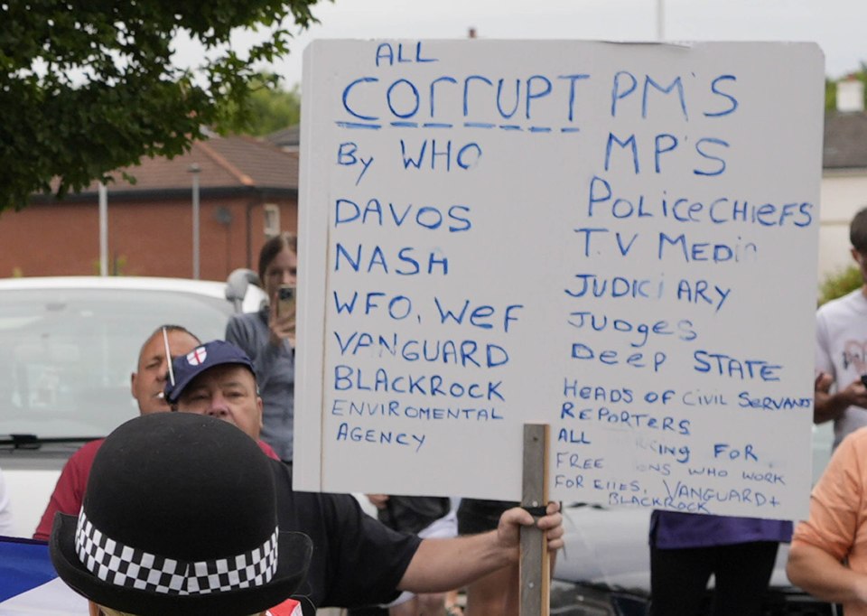 Lynch holding a sign outside the Holiday Inn Express in Rotherham during the riots