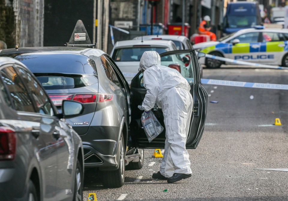 a man in a white suit is standing next to a honda civic