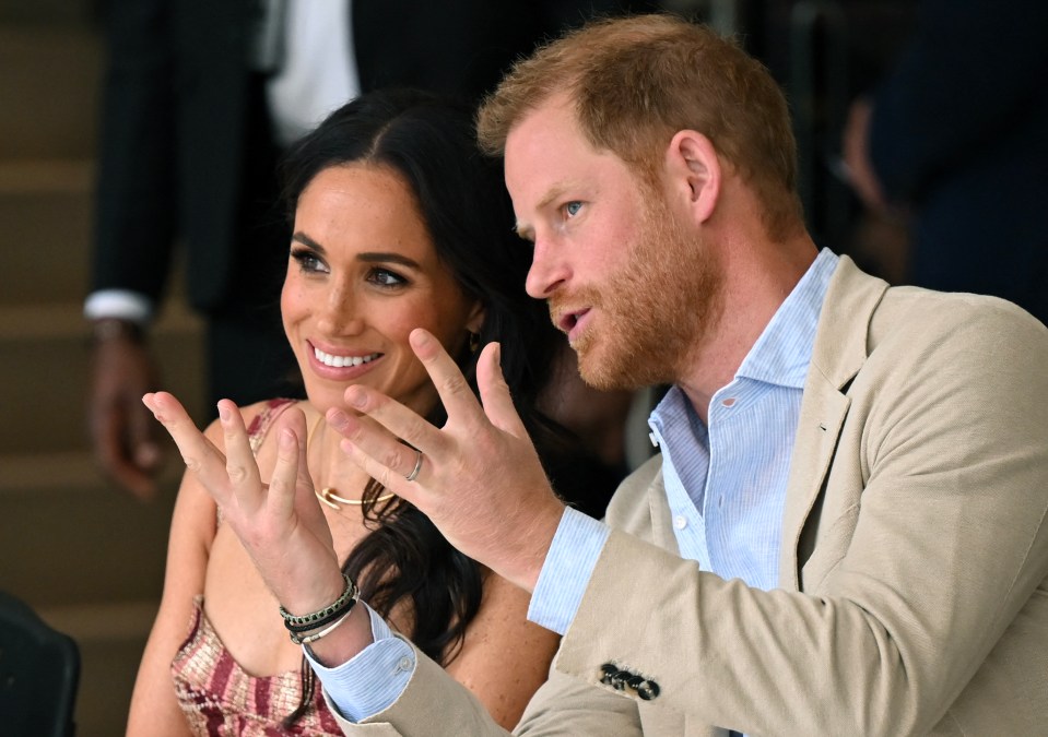 prince harry and meghan markle are sitting next to each other