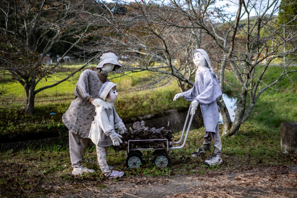 Another shot shows a family of mannequins collecting wood