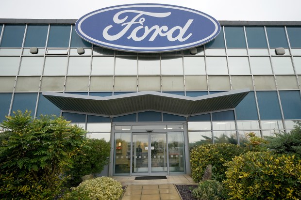 a large ford sign is above the entrance to a building