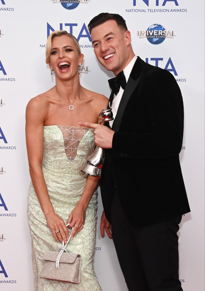 a man and a woman are posing for a picture at the nta national television awards