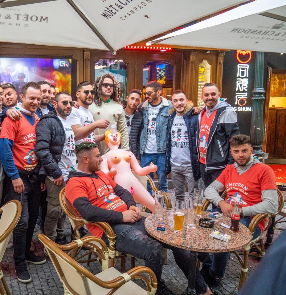 A stag party in a bar with comical t-shirts and a blow-up sex doll in Old Town, Prague