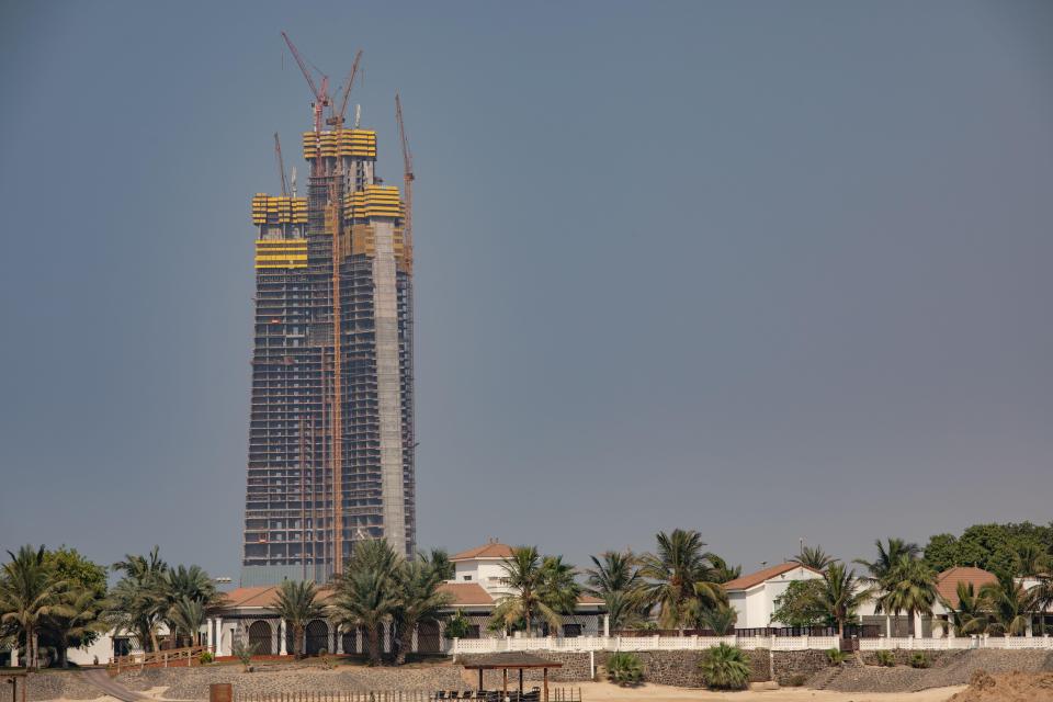 a very tall building is under construction in the middle of a city