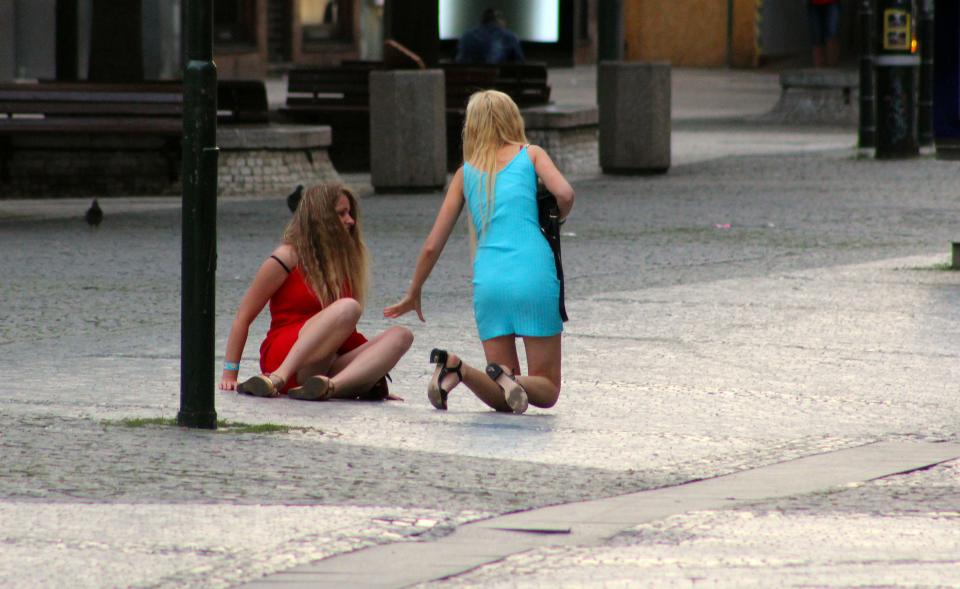 Two women from a hen party after falling on the street in Prague