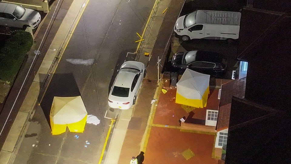 Aerial images show two tents erected on the residential street