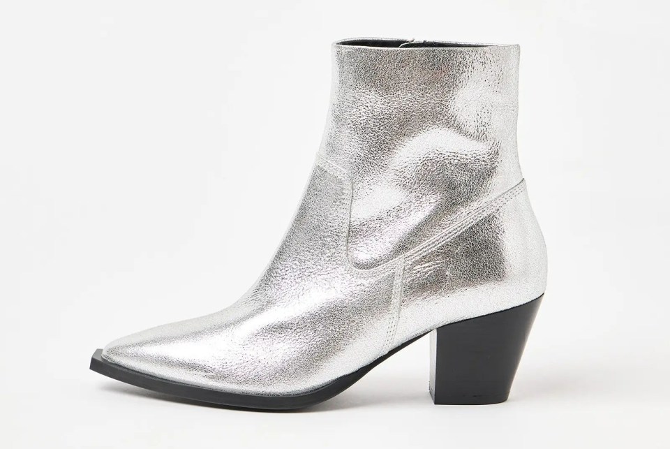 a pair of silver boots with a black heel